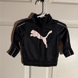 Puma brand little girls black jacket with a pink puma on the front.